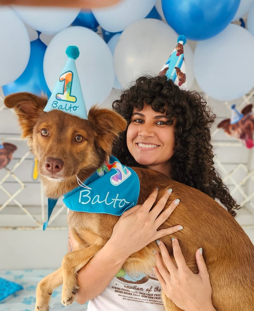 Dog celebrating its first birthday with a party hat and bandana, showcasing best first birthday ideas for dogs.